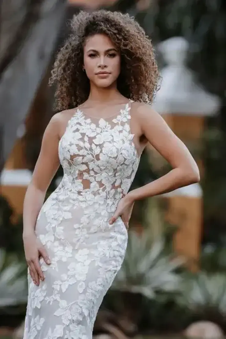 model is wearing a sleeveless lace fit and flare wedding gown