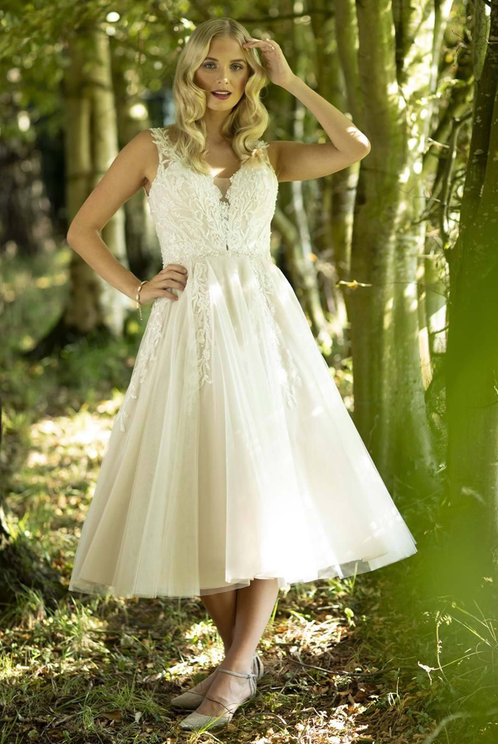 Model wearing a white Tea Lenght Style Dress