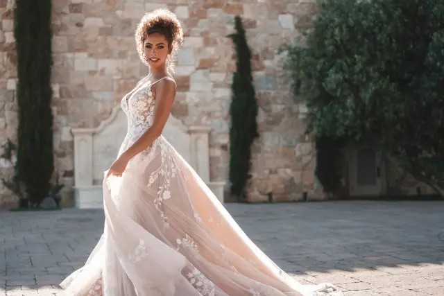 Model wearing a white Allure Bridals Dress