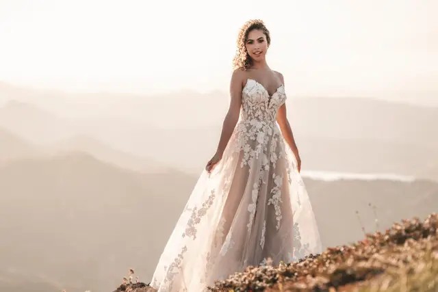 Model wearing a white Ballgown Style Dress