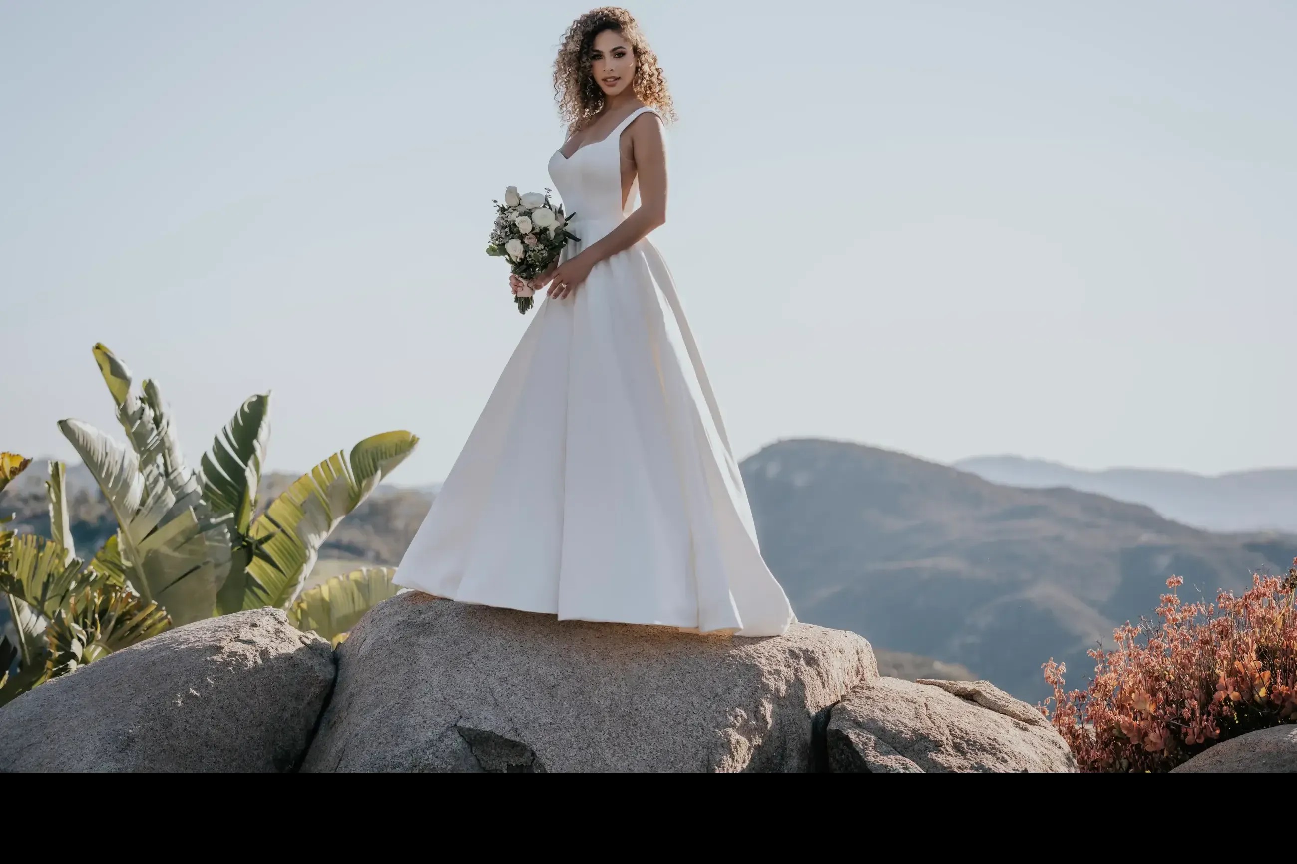 Model wearing a white Ballgown Style Dress