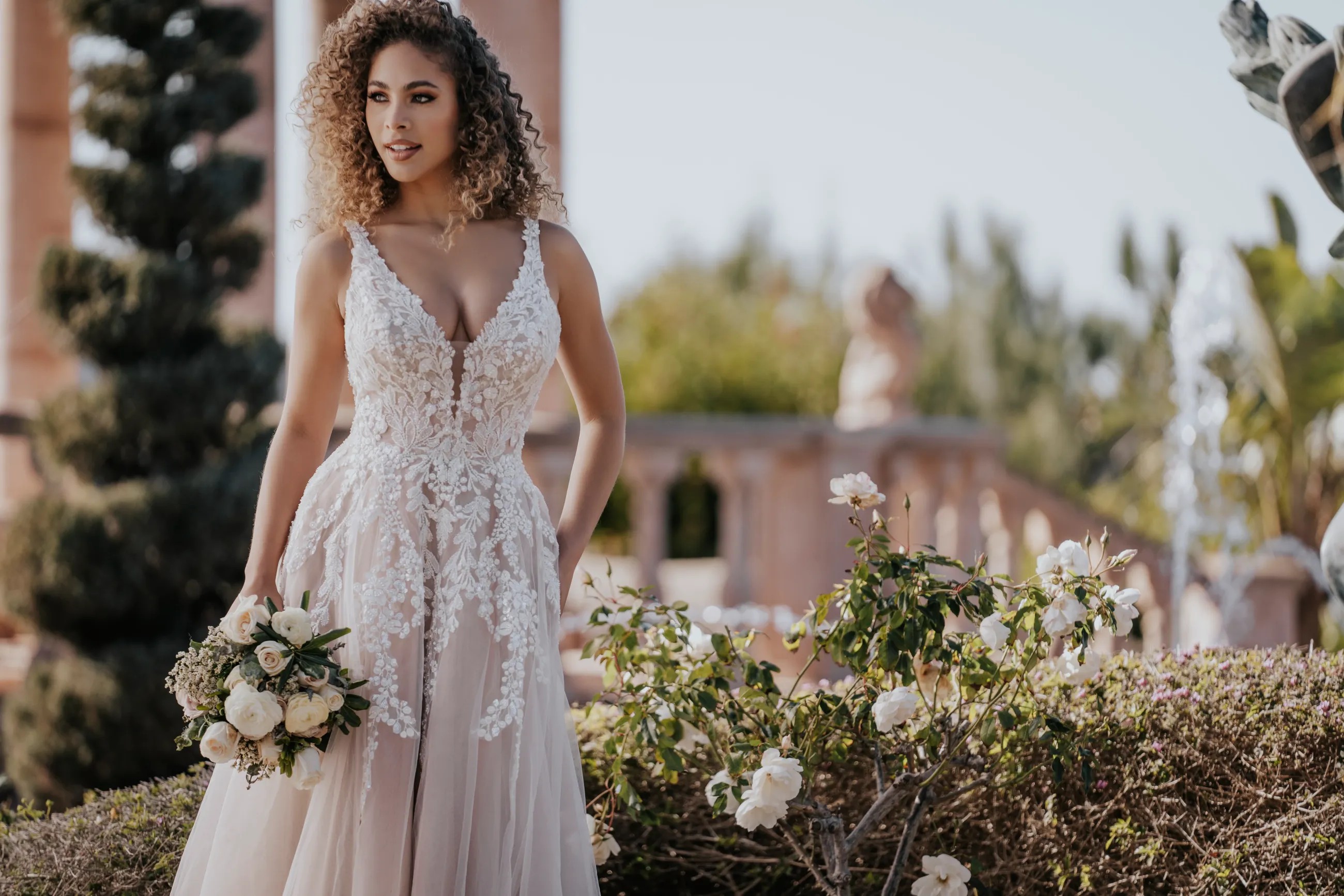Model wearing a white Allure Bridals Dress