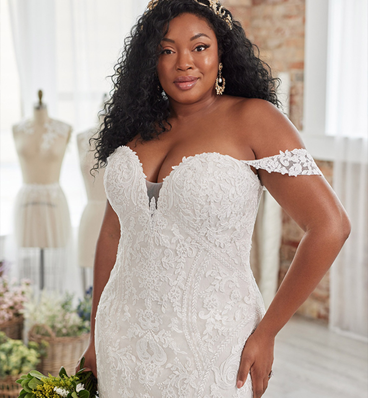 Plus size model wearing a white Maggie Sottero Gown